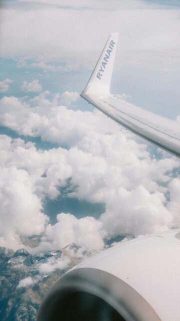 Stunning Ryanair Airplane Wing Over Snowy Mountains Cloudscape Wallpaper