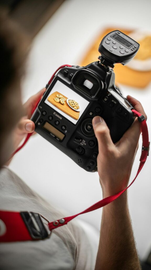 Professional Photographer Reviewing Food Photography Shot Mobile Wallpaper