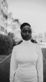 Elegant Black Woman in White Turtleneck Portrait Mobile Wallpaper