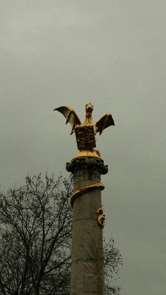 Golden Dragon Statue on Ancient Stone Pillar Minimalist Mobile Wallpaper