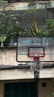 Urban Grunge Basketball Hoop Against Weathered Architecture Wallpaper