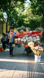 A Flower Vendor in Hanoi with Vibrant Colorful Bouquets Mobile Wallpaper
