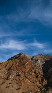 Majestic Golden Desert Mountain Peak Under Clear Blue Sky Wallpaper