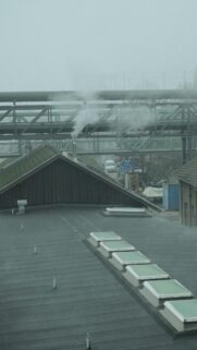 Industrial Misty Urban Rooftop with Steam Vents Phone Wallpaper