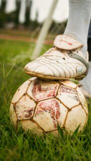 Close-up Soccer Cleat on Worn Ball High Quality Mobile Wallpaper