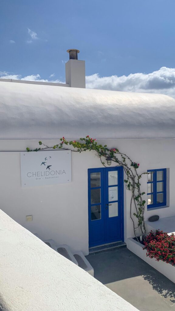 Iconic Santorini Architecture with Blue Doors and Bougainvillea Wallpaper