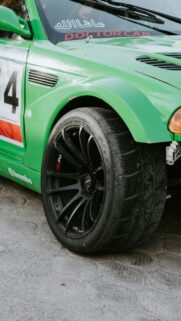Close-up Green Racing Drift Car Wheel and Tire Phone Wallpaper