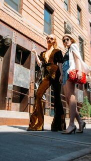 Two Fashionable Women in Chic Outfits Urban Street Style Wallpaper