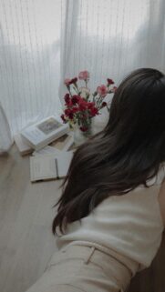 Aesthetic Girl Reading by Window with Flowers Mobile Wallpaper