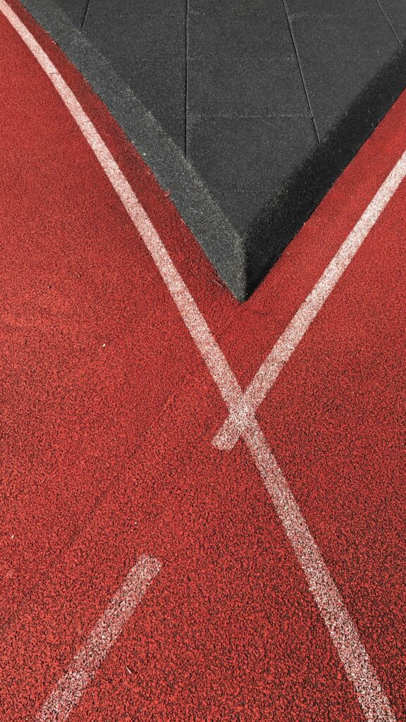 Abstract Red Track and Black Rubber Surface Minimalist Phone Wallpaper