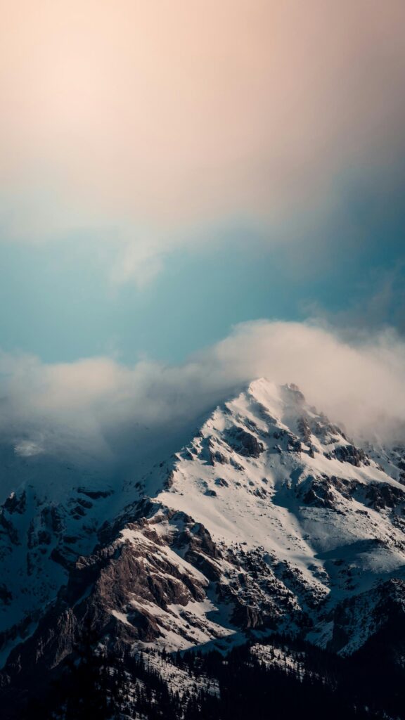 Majestic Snowy Mountain Peak Under Soft Clouds Mobile Wallpaper