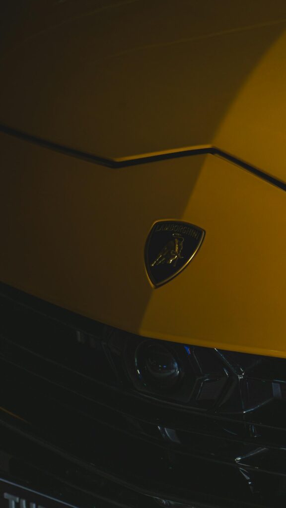 Lamborghini Emblem Close-up Yellow Sports Car Mobile Wallpaper