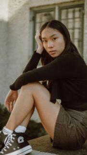 Asian Girl Sitting Outdoors Casual Fashion Portrait 4K Mobile Wallpaper