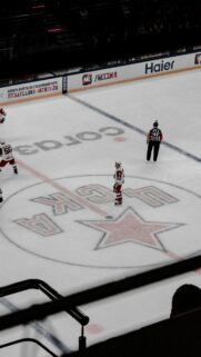 High Angle Shot of Ice Hockey Players and Referee on Arena Rink Wallpaper