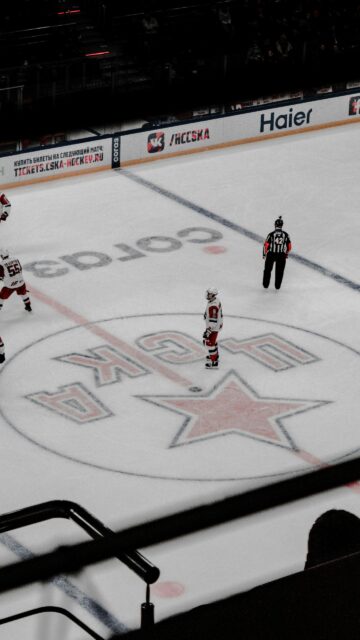 High Angle Shot of Ice Hockey Players and Referee on Arena Rink Wallpaper