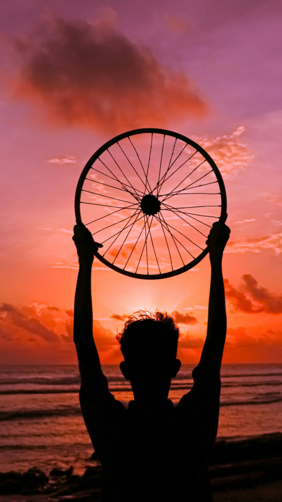 Bicycle Wheel Sunset Vision Board for Forward Motion and Manifestation Wallpaper