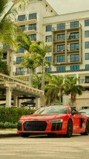 Red Audi R8 Supercar Parked at Tropical Resort Mobile Wallpaper