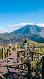 Woman Looking at Arenal Volcano Scenic View Mobile Wallpaper