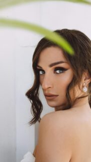 Stunning Portrait of a Woman with Intense Eyes and Elegant Makeup Wallpaper