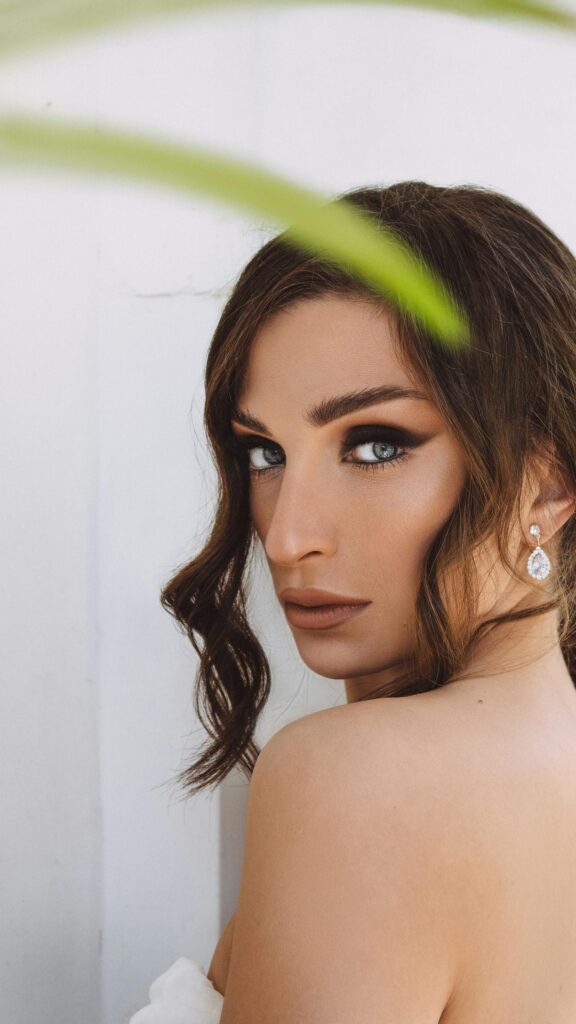 Stunning Portrait of a Woman with Intense Eyes and Elegant Makeup Wallpaper
