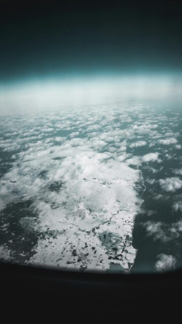 Stunning Aerial Winter Landscape with Snowy Fields and Ocean Wallpaper