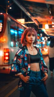 Urban Street Style Woman with Pink Hair Night City Life Wallpaper