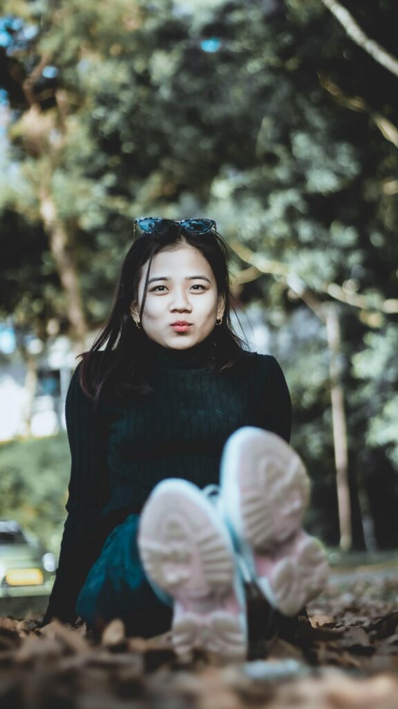 Beautiful Young Asian Woman Posing Outdoors Phone Wallpaper