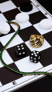 Luxury Gold Jewelry and Game Dice on Chessboard Aesthetic Wallpaper