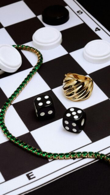Luxury Gold Jewelry and Game Dice on Chessboard Aesthetic Wallpaper