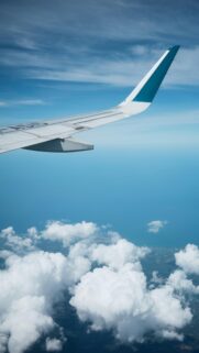 Serene Airplane Wing Above Clouds Sky Blue Travel Phone Wallpaper
