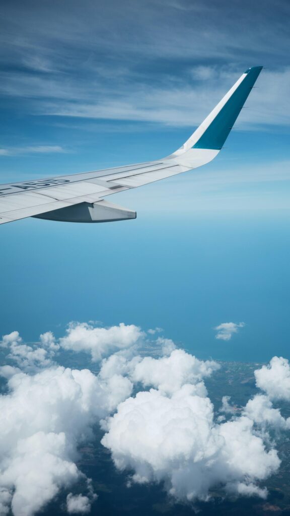 Serene Airplane Wing Above Clouds Sky Blue Travel Phone Wallpaper