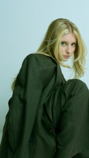Stylish Blonde Model in Oversized Suit Minimalist Fashion Wallpaper