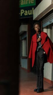 Stylish Young Man in Vibrant Red Coat Fashion Portrait Wallpaper