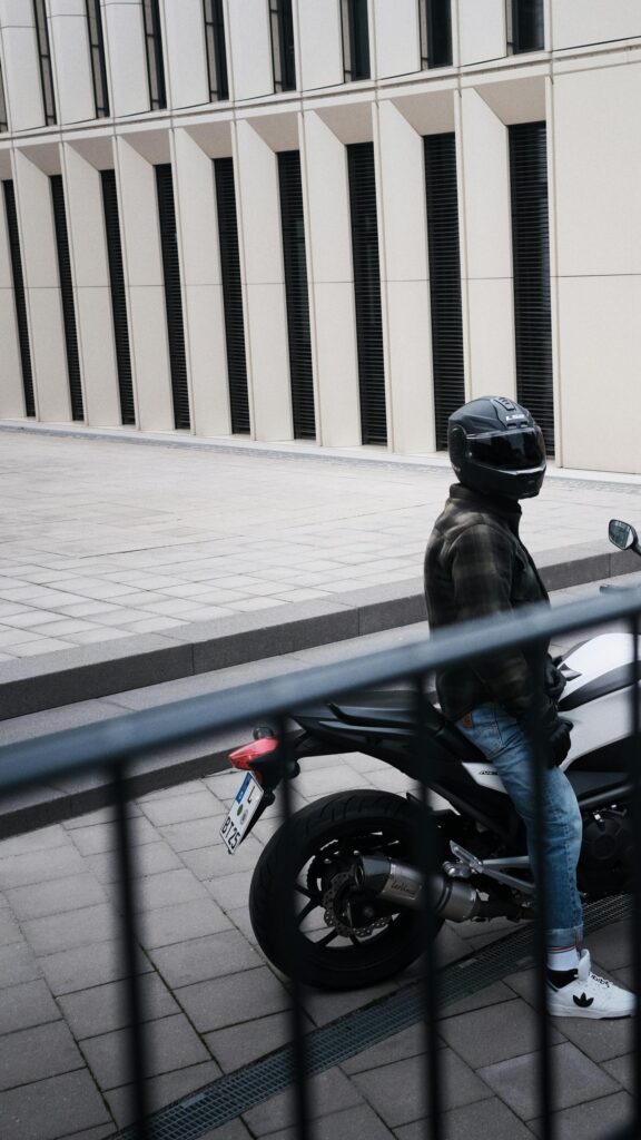 Biker in Plaid Jacket on Sport Bike Urban Street Style Wallpaper