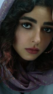Stunning Portrait of a Young Woman with Curly Hair Phone Wallpaper