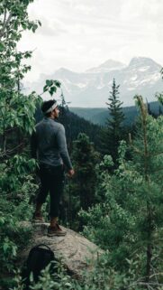 Man Standing on Mountain Overlook During Hike Phone Wallpaper