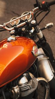 Vibrant Orange Royal Enfield Motorcycle Fuel Tank Close-Up Phone Wallpaper