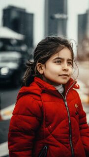 Young Girl in Red Puffer Jacket Winter Portrait Mobile Wallpaper