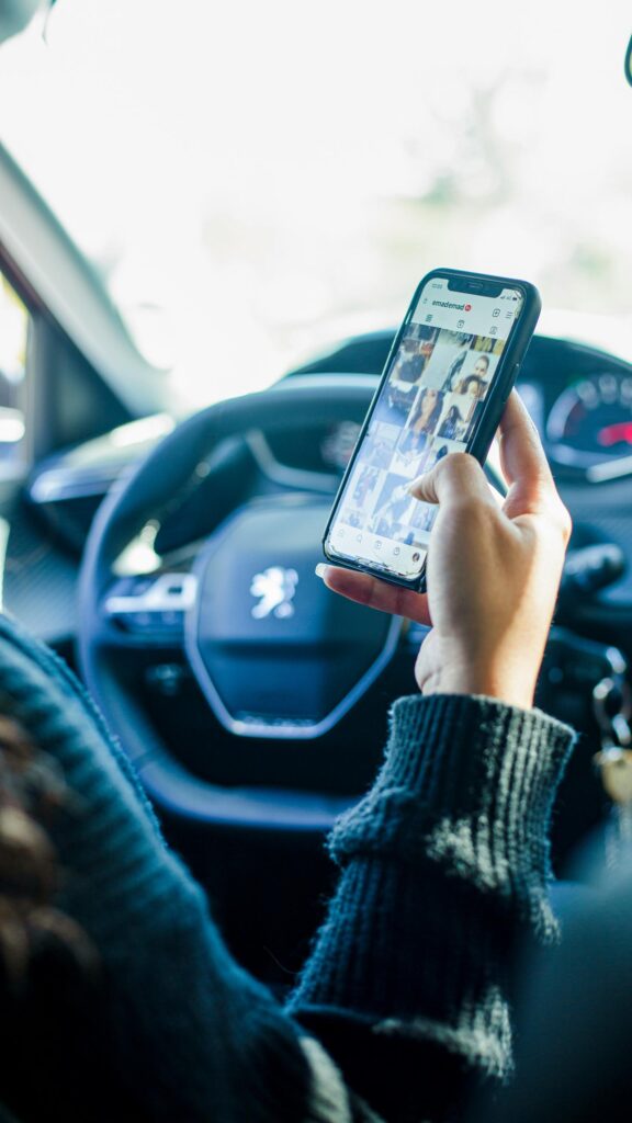 Person Browsing Instagram on Smartphone in Peugeot Car Wallpaper