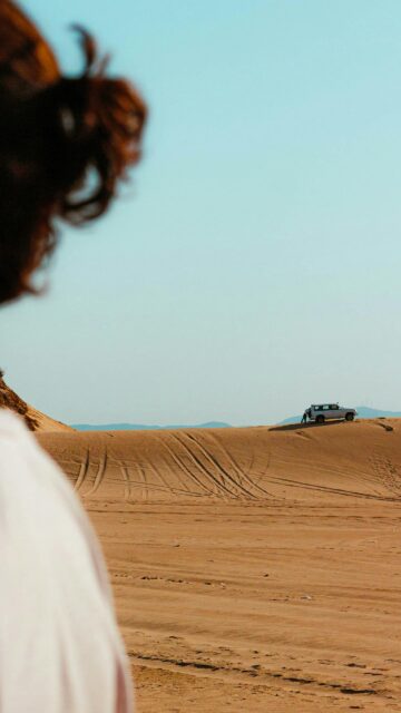 Lone 4x4 Off-Road Adventure on Golden Desert Sand Dunes Wallpaper