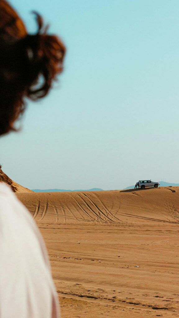 Lone 4x4 Off-Road Adventure on Golden Desert Sand Dunes Wallpaper