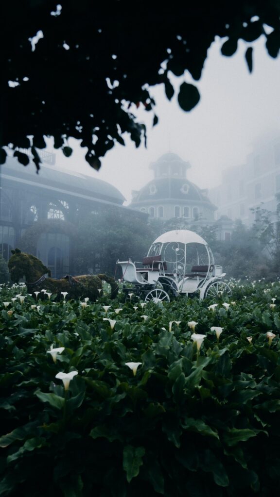 Enchanting Fairy Tale Carriage in Misty Flower Garden Wallpaper