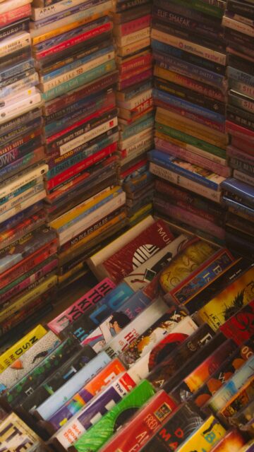 High-Angle Stacked Book Collection Aesthetic Mobile Wallpaper