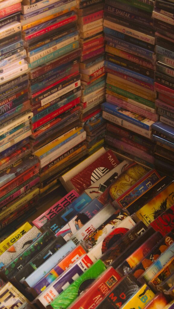 High-Angle Stacked Book Collection Aesthetic Mobile Wallpaper