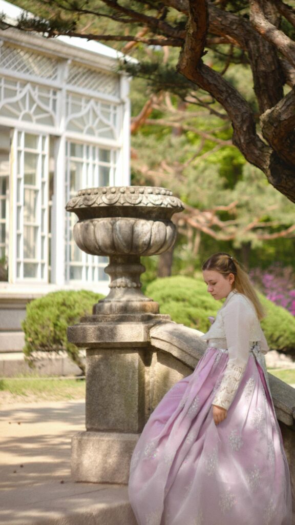 Elegant Girl in Traditional Hanbok Garden Portrait Mobile Wallpaper