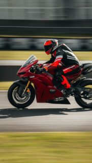 Red Ducati Sportbike Speeding on Racetrack Mobile Wallpaper
