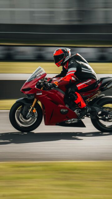 Red Ducati Sportbike Speeding on Racetrack Mobile Wallpaper