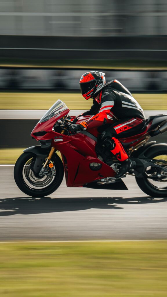 Red Ducati Sportbike Speeding on Racetrack Mobile Wallpaper