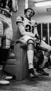 American Football Player Focused in Locker Room Portrait Wallpaper