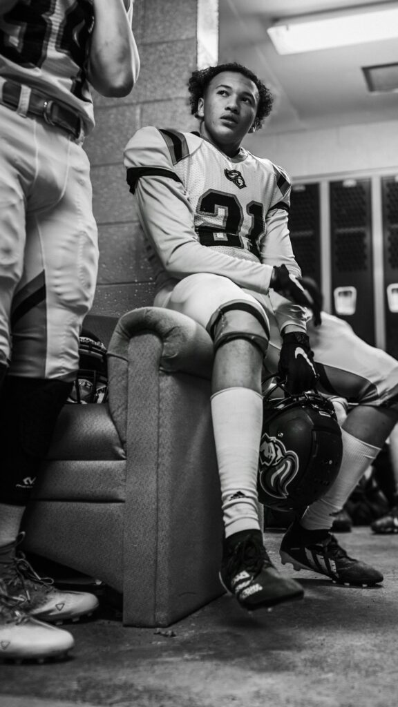 American Football Player Focused in Locker Room Portrait Wallpaper